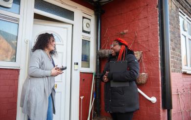 Sanctuary staff speaking to a resident outside their house