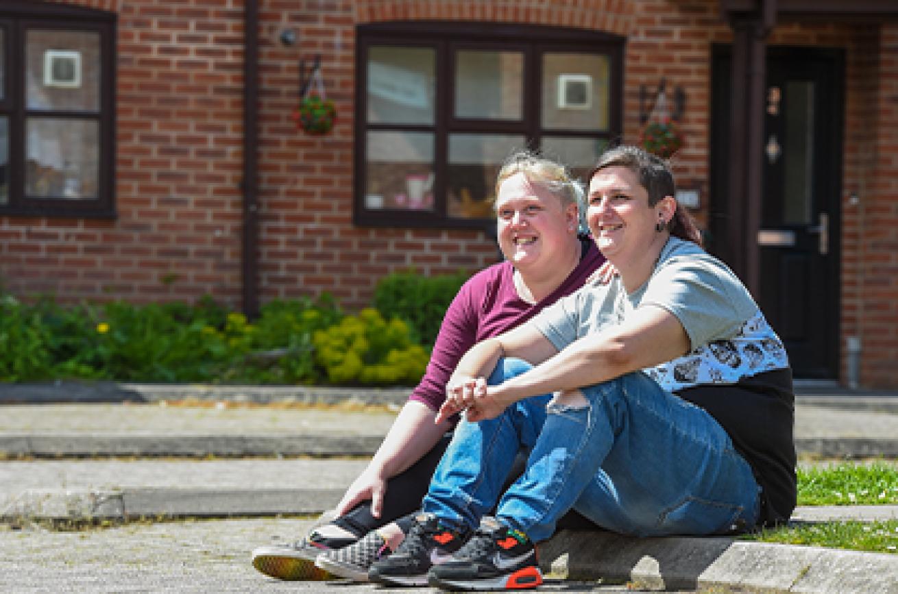 Sanctuary residents siting on a curb Sanctuary residents siting on a curb