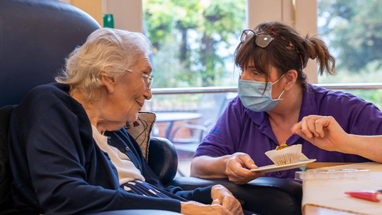 Sanctuary Care staff talking with a resident Sanctuary Care staff talking with a resident