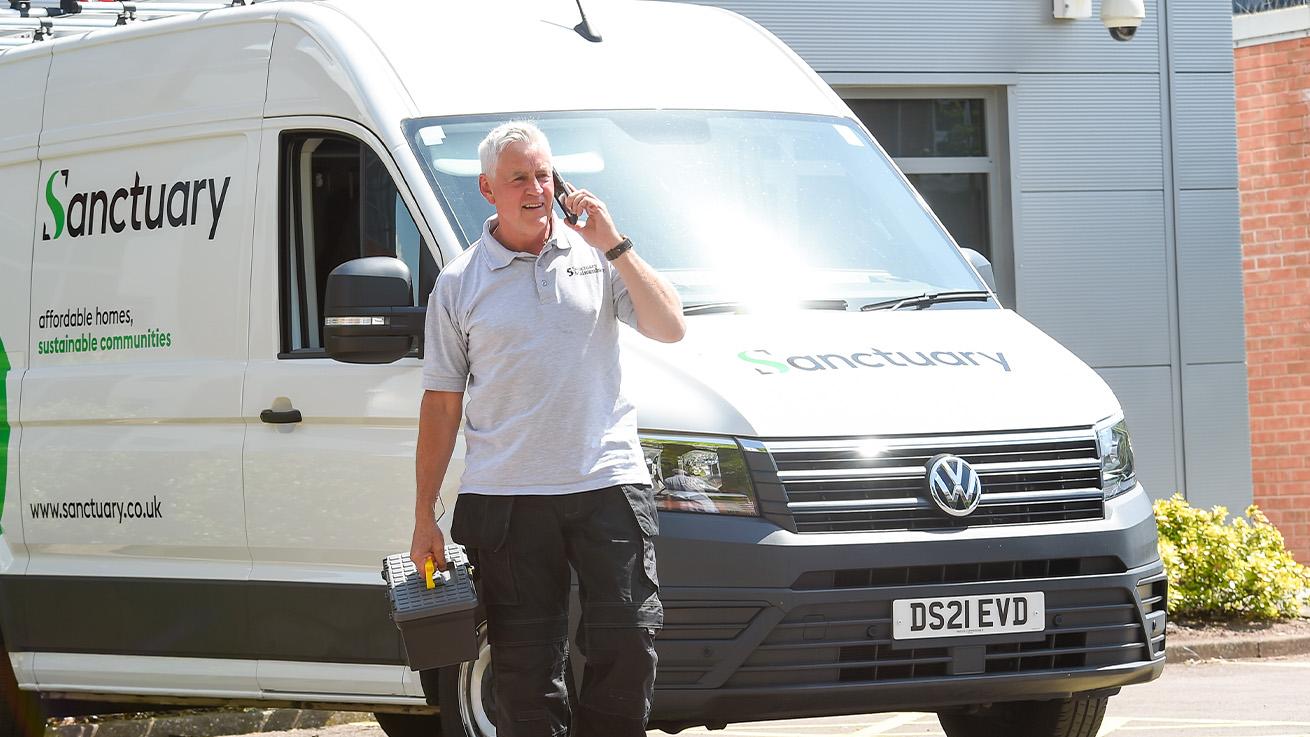 Man walking next to Sanctuary maintenance van Man walking next to Sanctuary maintenance van