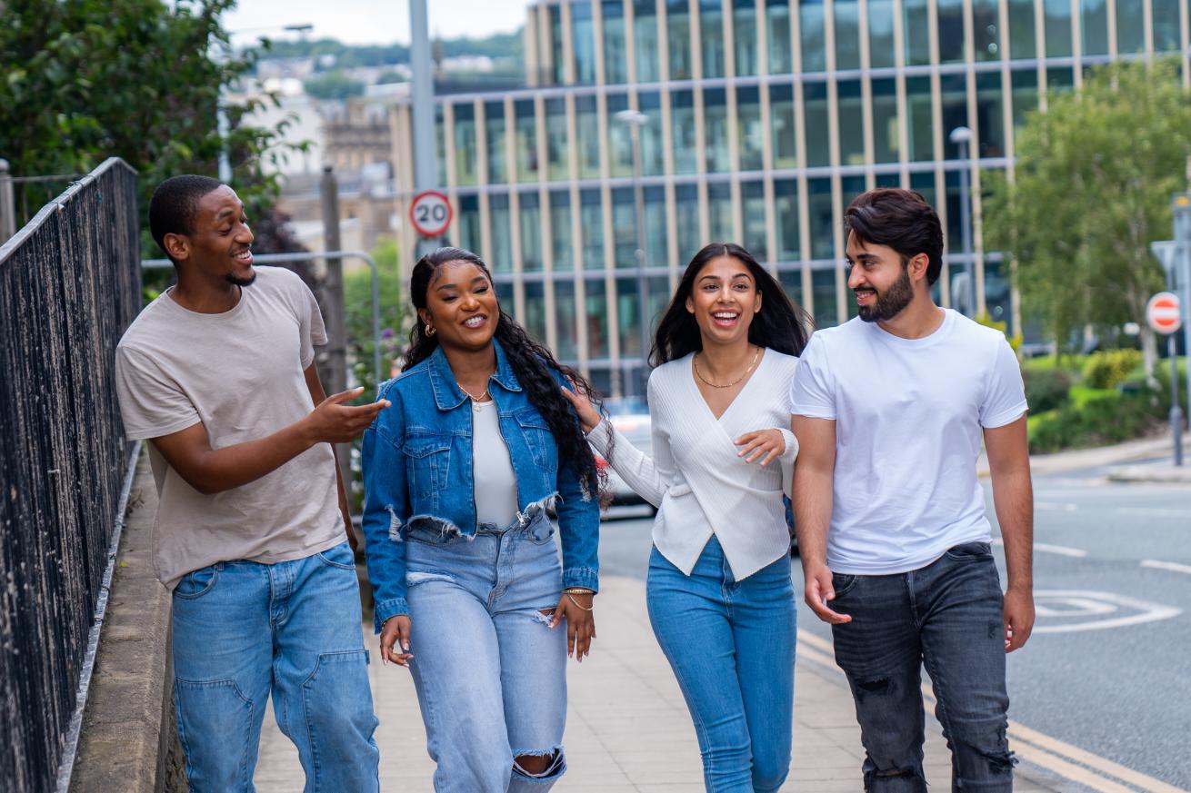 A group of young people walk in the street