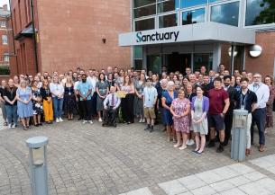 A large group of Sanctuary employees stood outside the head office in Worcester